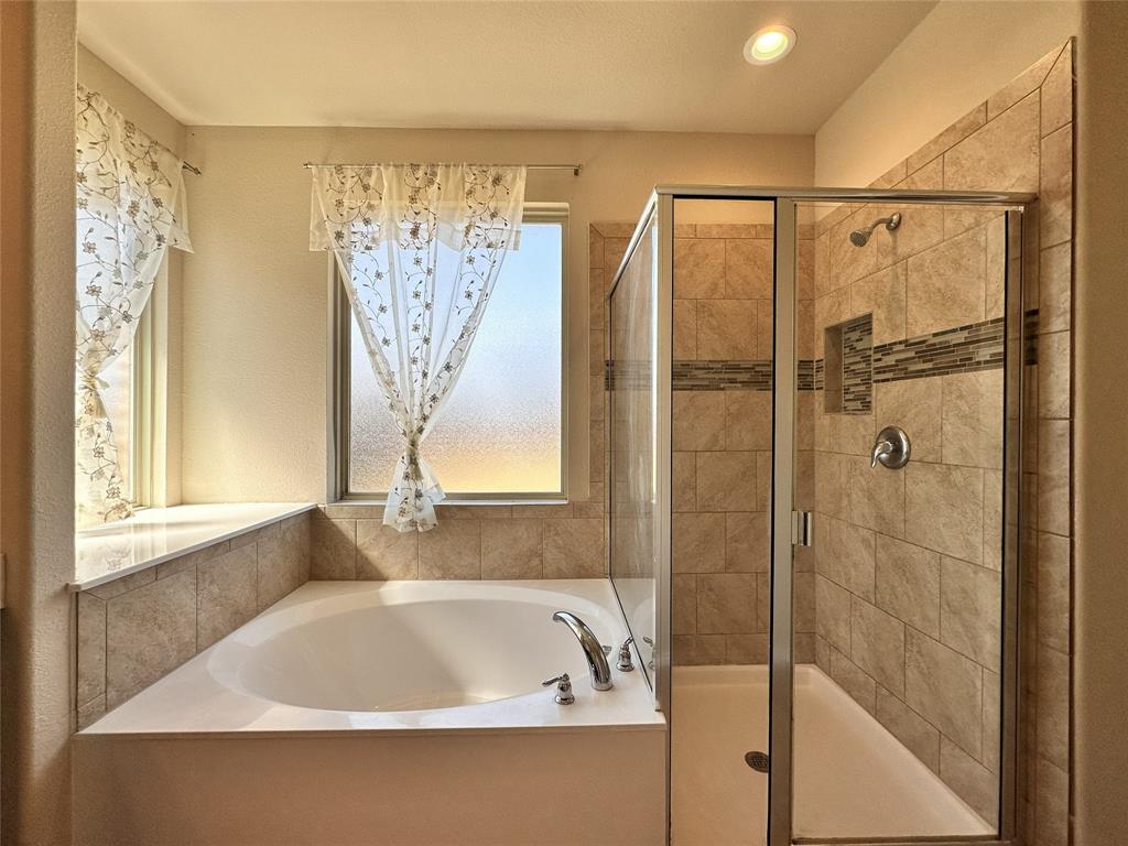 304 Cypress Crk Lane Denton, TX 76210 - Photo 12 of 24 a bathroom with a bathtub and shower