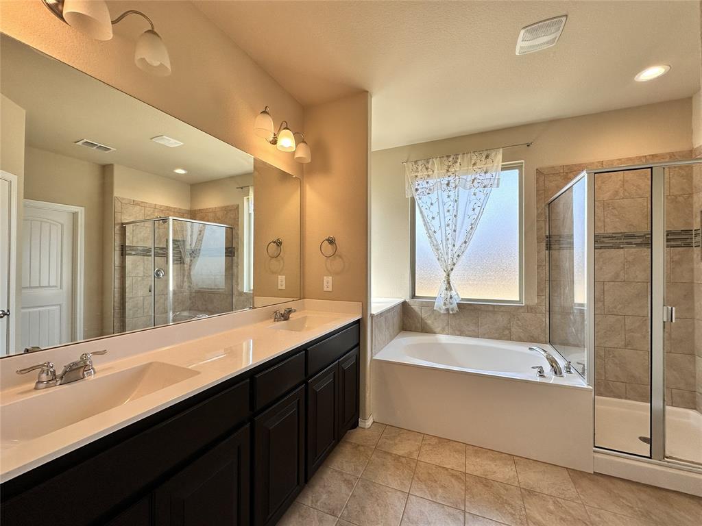304 Cypress Crk Lane Denton, TX 76210 - Photo 13 of 24 a bathroom with a large tub sink and double vanity