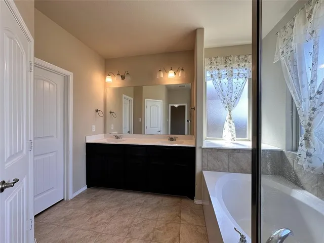 a bathroom with a bathtub and shower