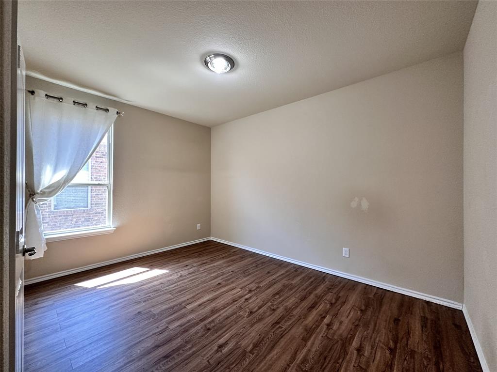 304 Cypress Crk Lane Denton, TX 76210 - Photo 15 of 24 an empty room with wooden floor and windows