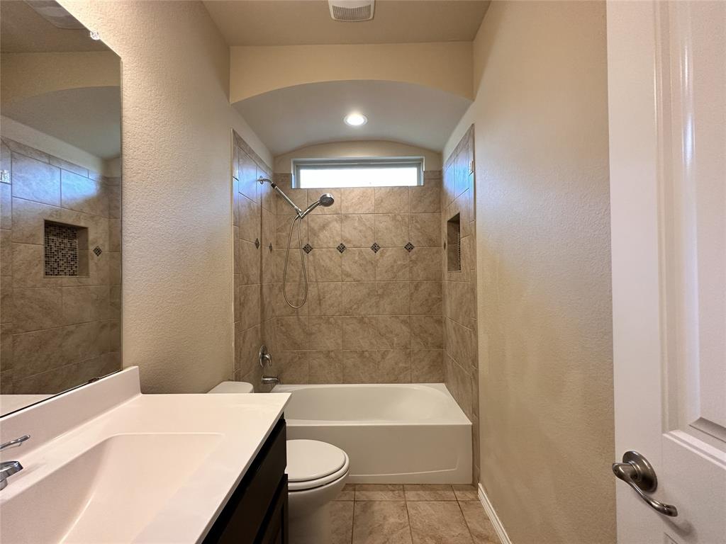 304 Cypress Crk Lane Denton, TX 76210 - Photo 17 of 24 a bathroom with a sink a toilet a bathtub and shower