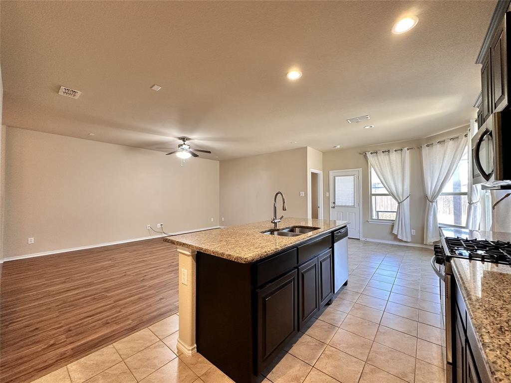304 Cypress Crk Lane Denton, TX 76210 - Photo 23 of 24 a kitchen with a stove and a wooden floor