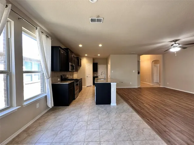 a view of kitchen with sink and wooden floor