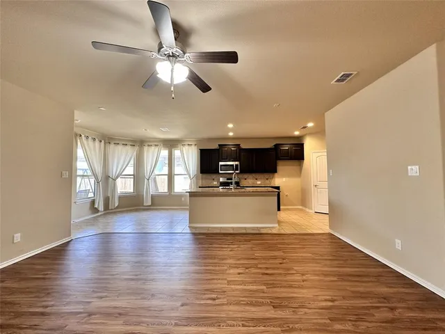 a kitchen with granite countertop a stove and a sink