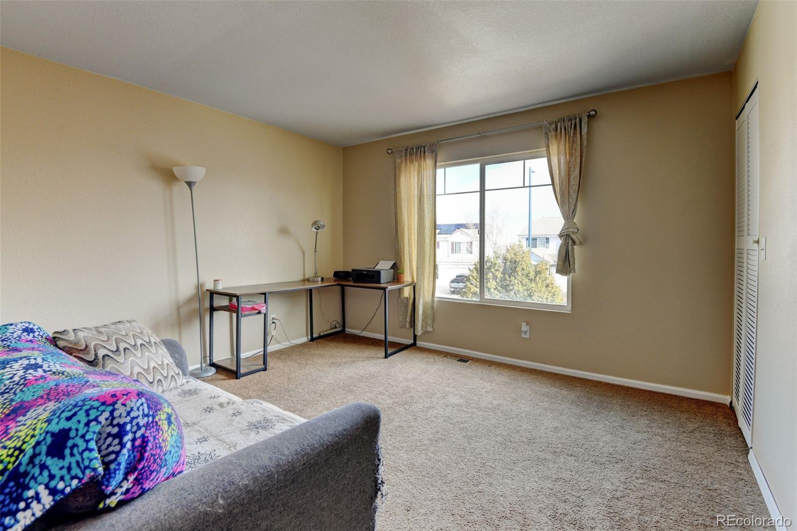 5555 Perth Court Denver, CO 80249 - Photo 14 of 31 a bedroom with a bed and a window