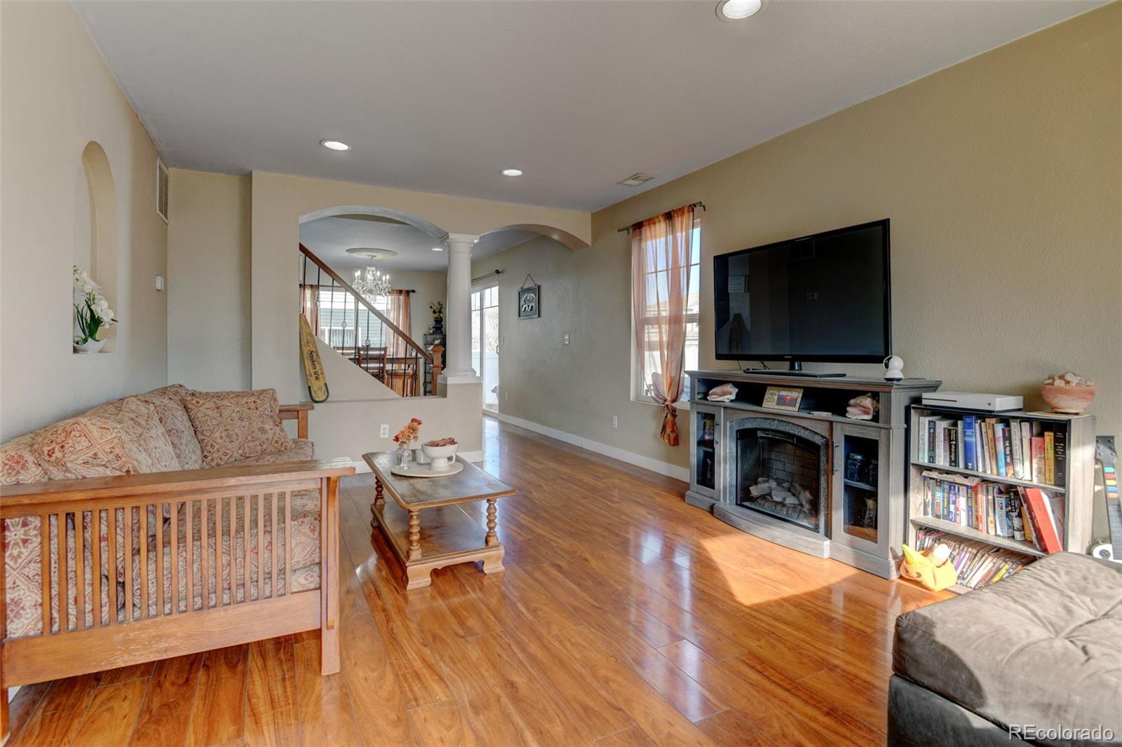 5555 Perth Court Denver, CO 80249 - Photo 5 of 31 a living room with furniture and a flat screen tv