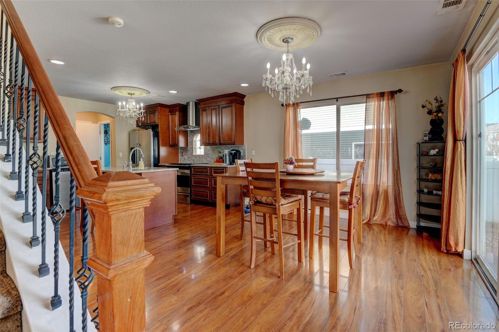 5555 Perth Court Denver, CO 80249 - Photo 6 of 31 a view of a dining room with furniture window and wooden floor