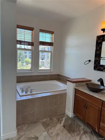 a view of a double vanity sink mirror and outdoor space