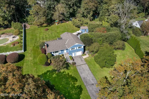 an aerial view of a house with yard