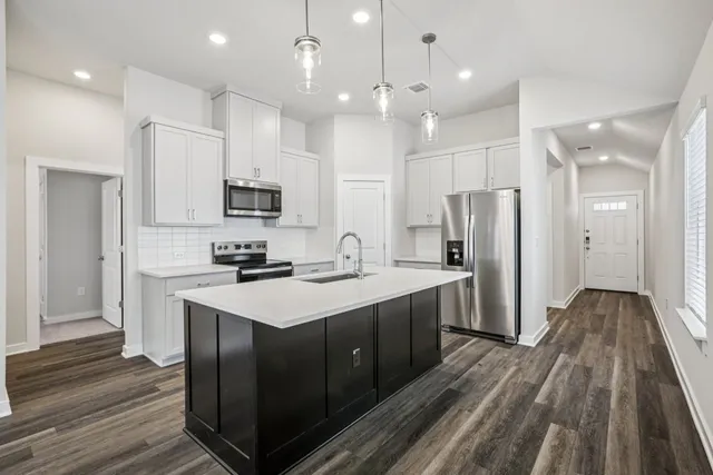 a kitchen with a sink stainless steel appliances and cabinets