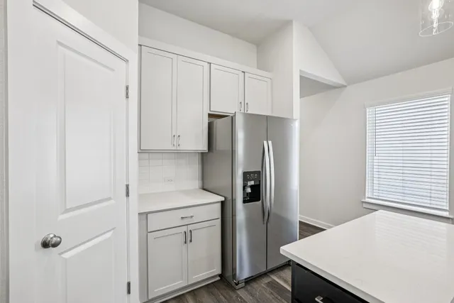 a kitchen with a sink and wooden floor