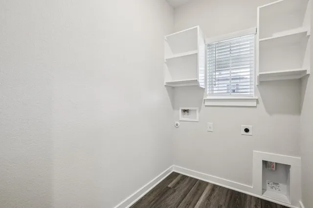 a kitchen with a refrigerator and white cabinets