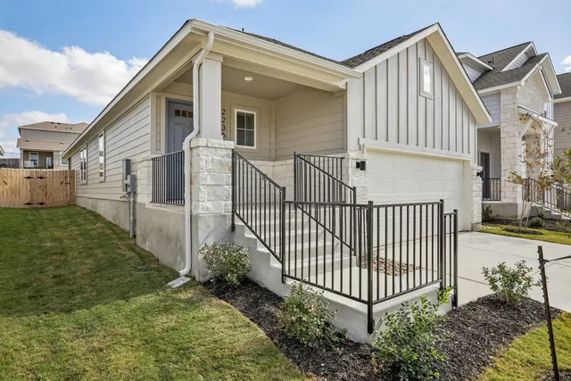 a view of a house with a yard and deck