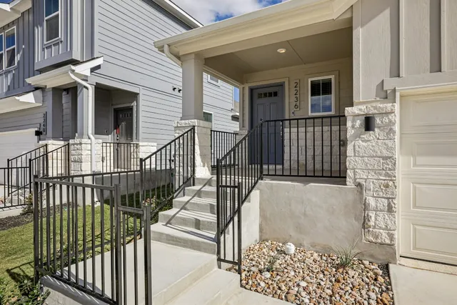 a view of a house with iron fence