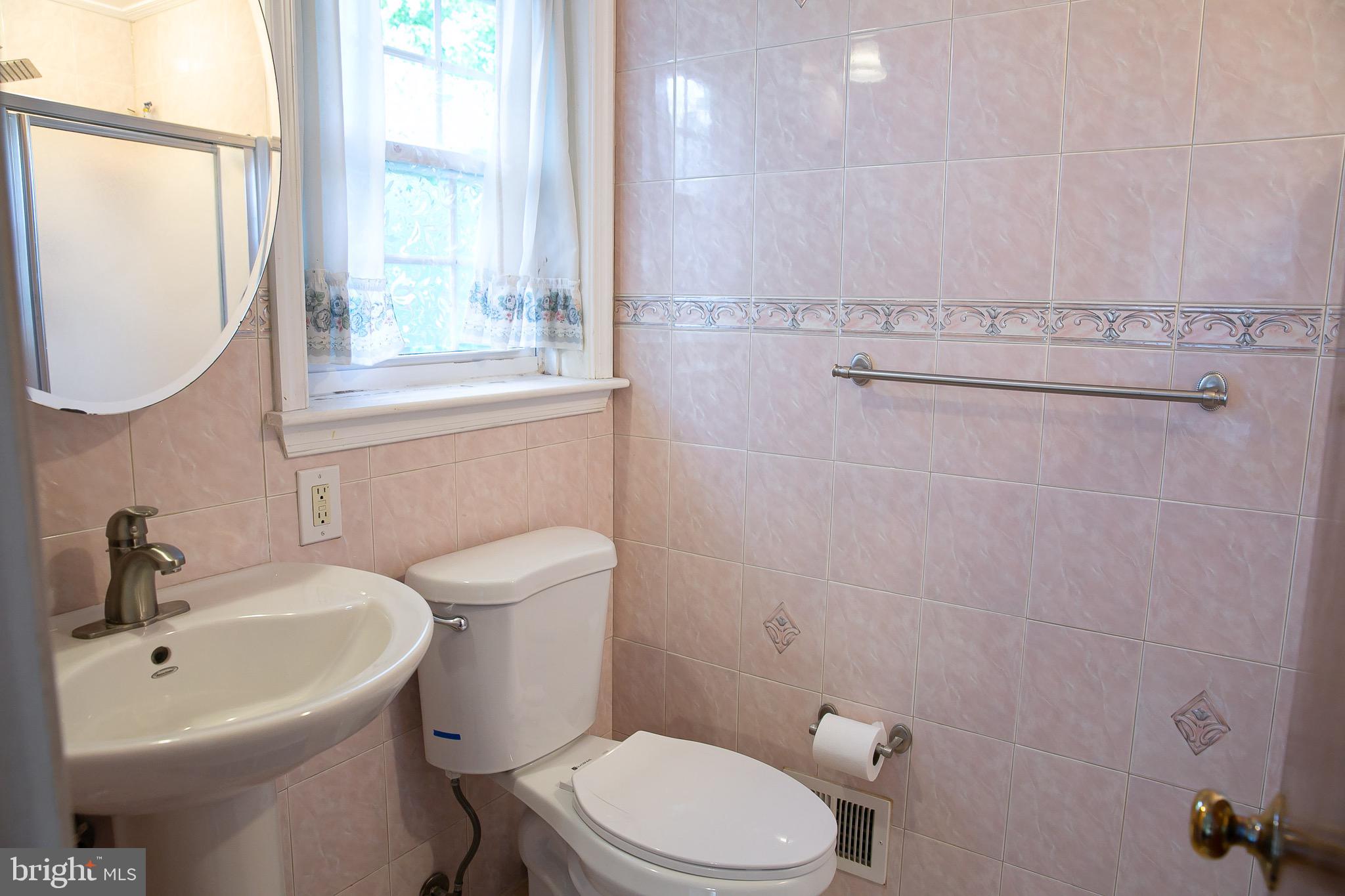 1395 Varnum Drive Wayne, PA 19087 - Photo 16 of 21 a bathroom with a sink a toilet and a mirror