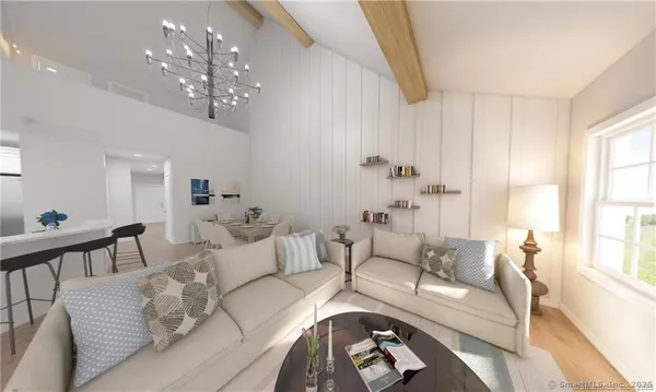 a living room with furniture and a chandelier