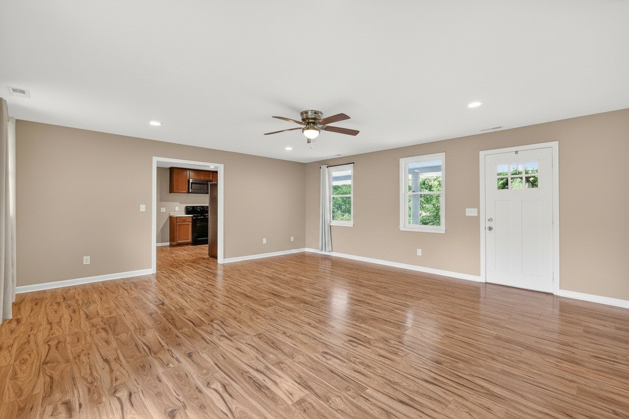 11914 Hogwood Road Milton, TN 37118 - Photo 13 of 44 a view of an empty room with a window and wooden floor