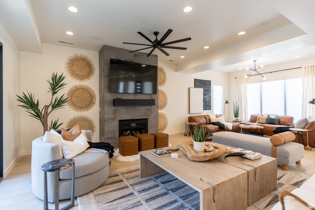 5355 Cyan Lane St. George, UT 84790 - Photo 9 of 39 Spacious living area featuring a stone-clad fireplace, recessed lighting, and a prominent ceiling fan