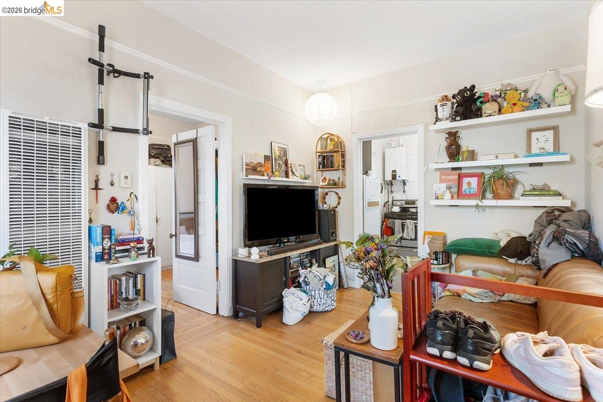 3110 California Street Berkeley, CA 94703 - Photo 7 of 41 Living room with light wood finished floors, a heating unit, and tankless water heater