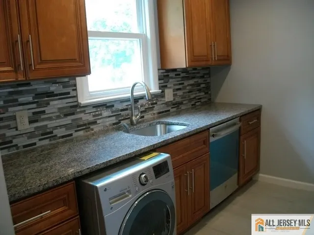 a kitchen with a sink and a window