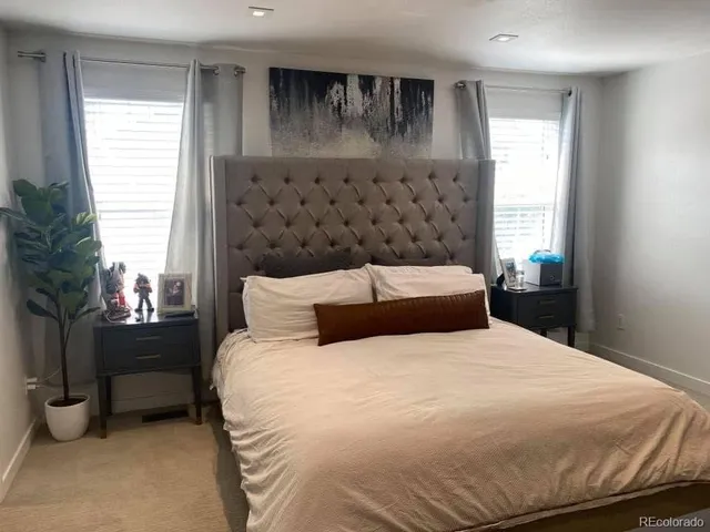 a bedroom with a large bed and a window