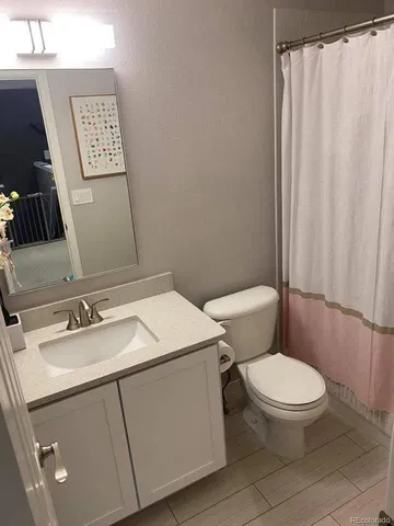 a white toilet sitting next to a bathroom sink
