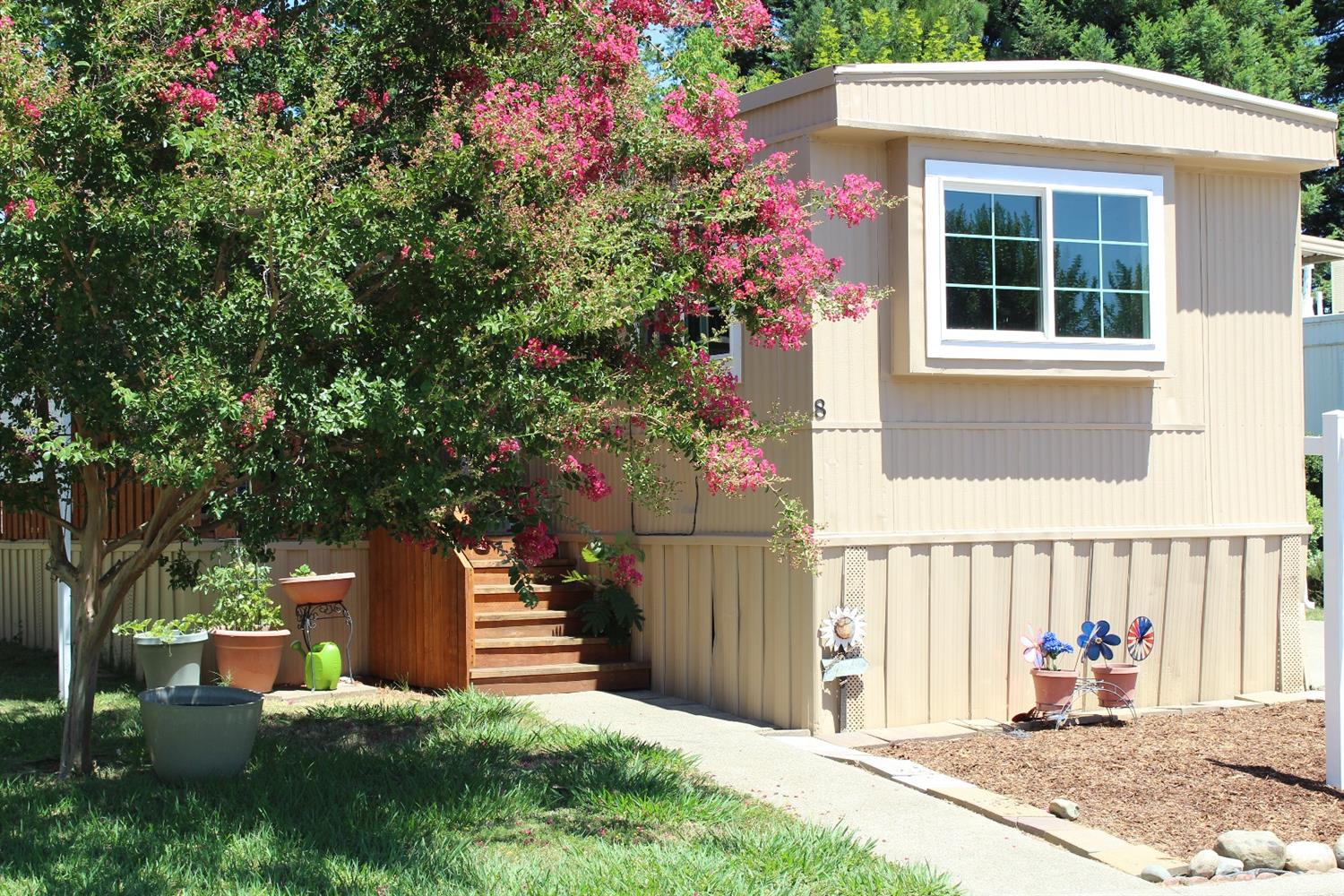 a front view of a house with a garden
