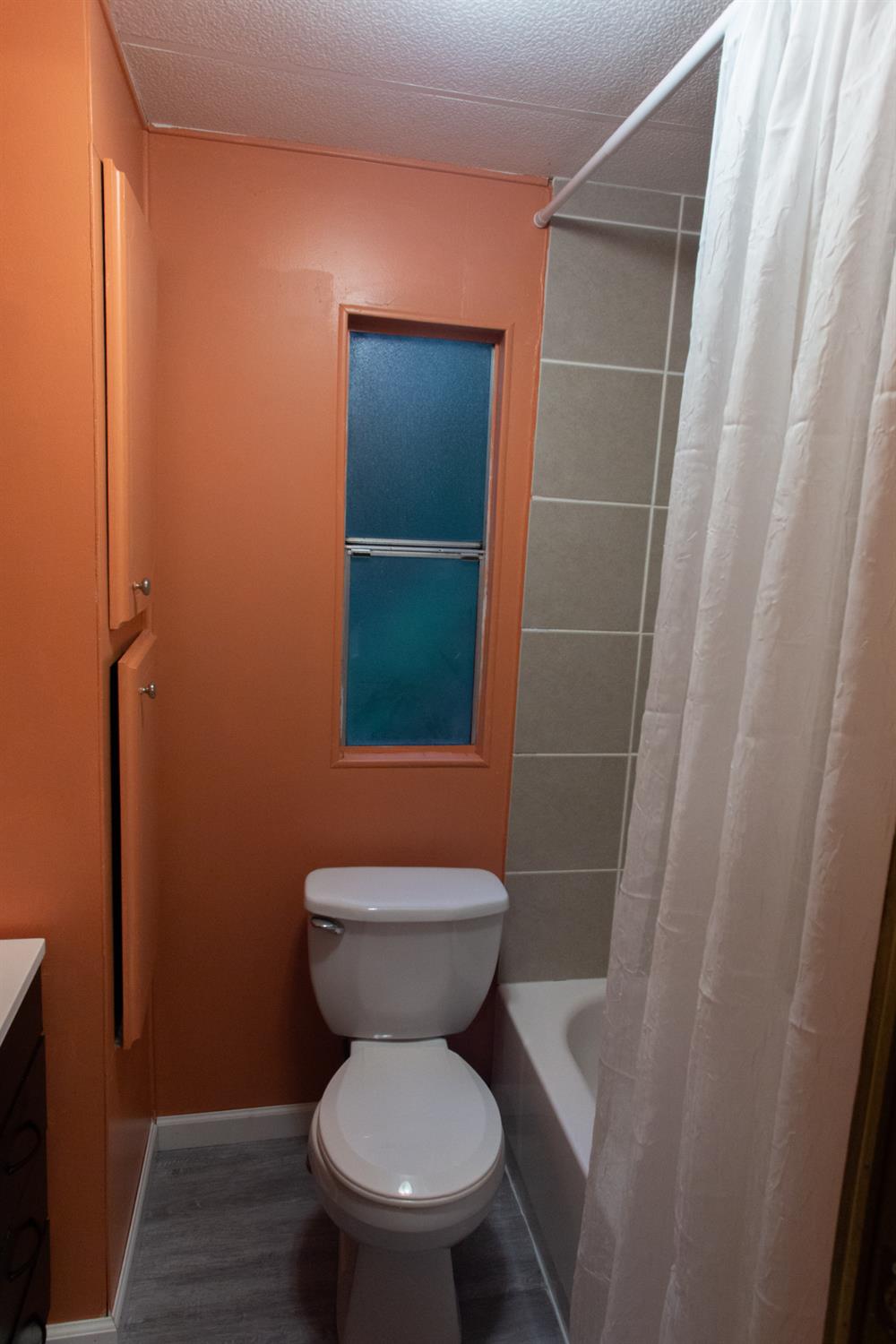 350 Pleasant Valley Road, Unit 8 Diamond Springs, CA 95619 - Photo 16 of 26 a bathroom with a toilet and a shower