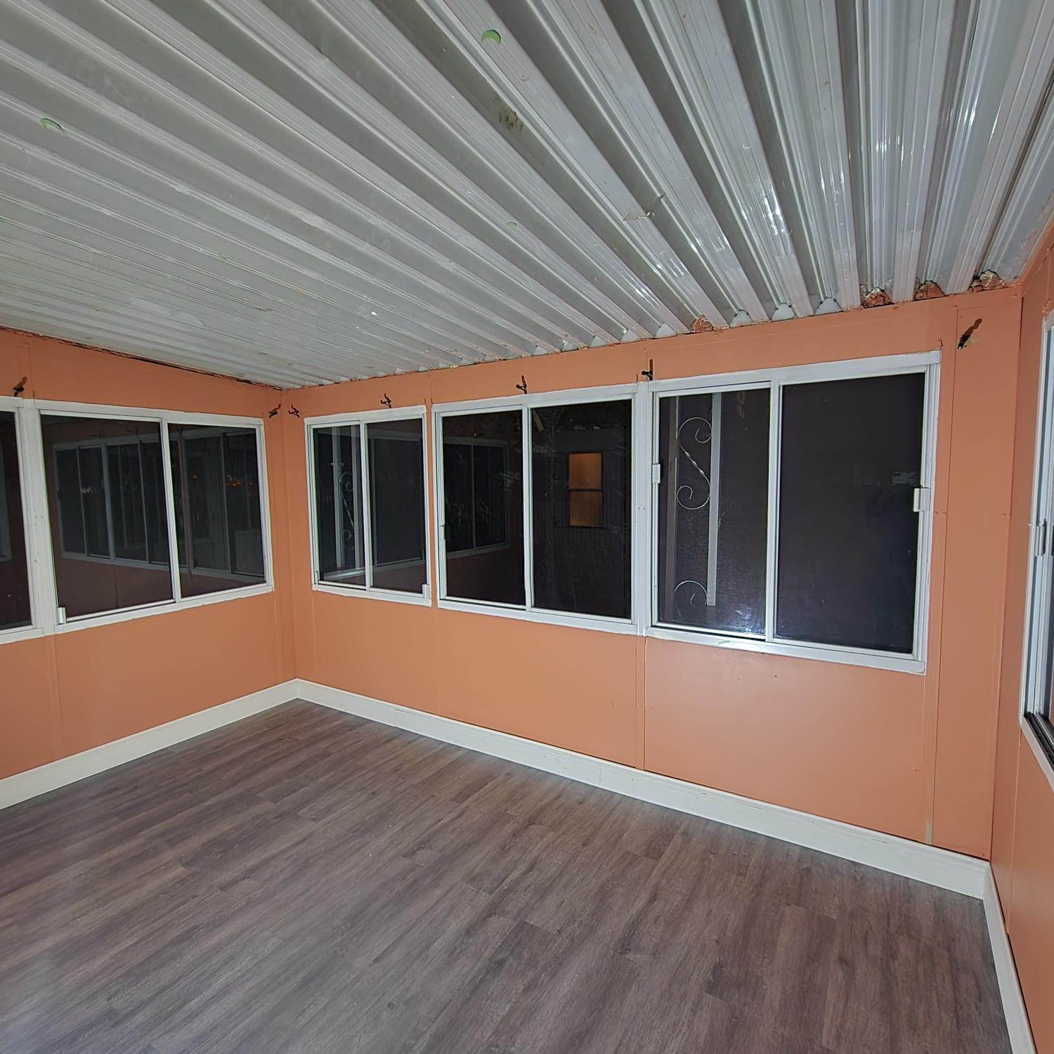 350 Pleasant Valley Road, Unit 8 Diamond Springs, CA 95619 - Photo 20 of 26 a view of an empty room with wooden floor and a window