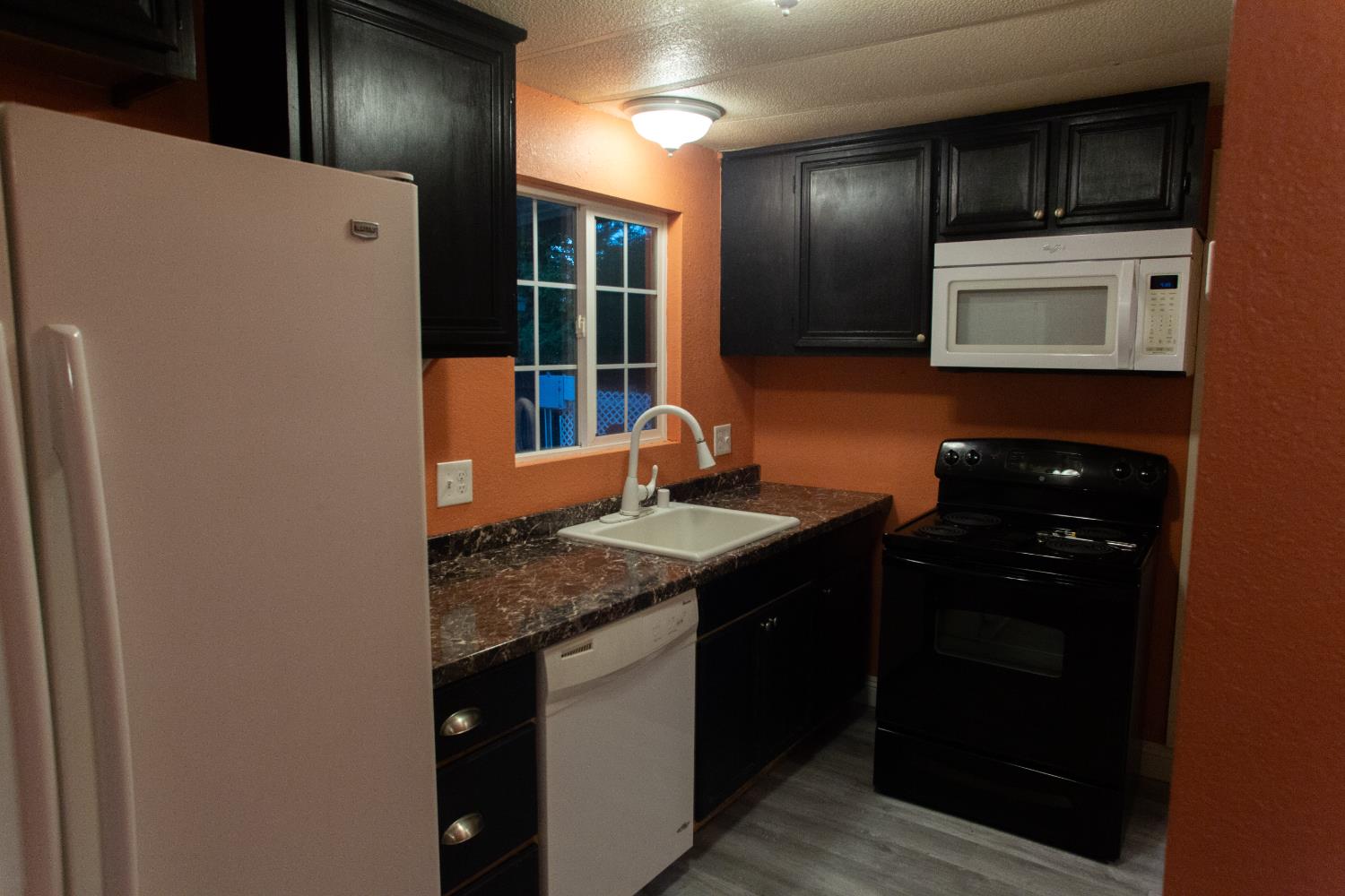 350 Pleasant Valley Road, Unit 8 Diamond Springs, CA 95619 - Photo 4 of 26 a kitchen with stainless steel appliances granite countertop a sink and a refrigerator