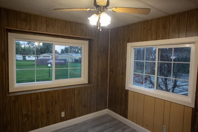 a view of empty room with wooden floor