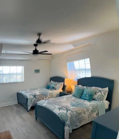 a bedroom with a bed a dresser and a large mirror