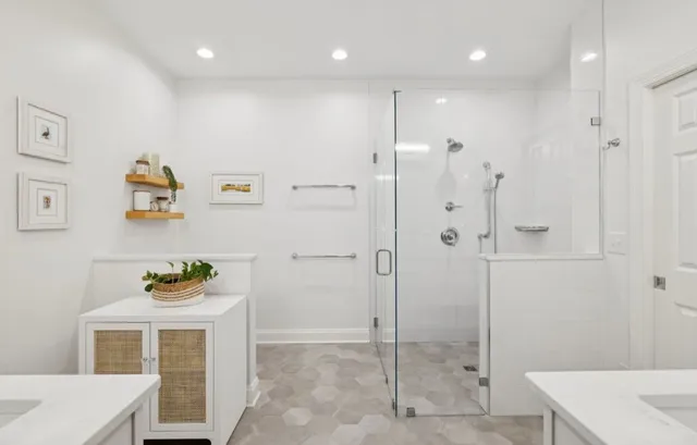 a bathroom with a shower a sink and a mirror