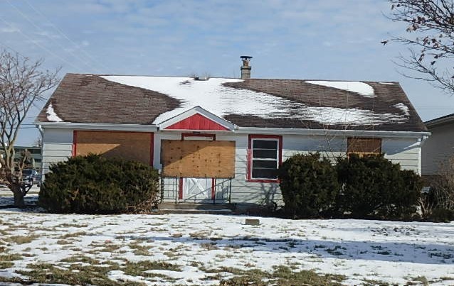 a view of a house with snow on the side of it