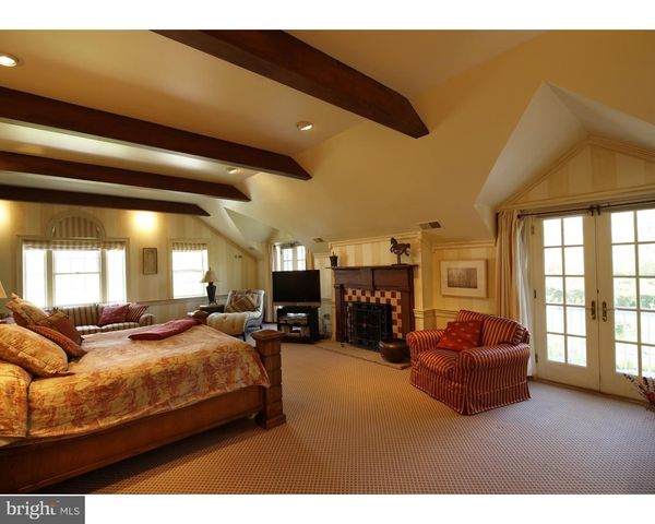 a living room with furniture fireplace and a large window