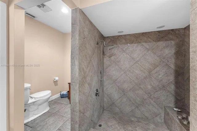 a bathroom with a toilet and a shower