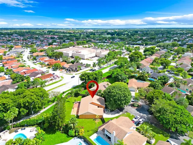 an aerial view of residential houses with outdoor space and street view
