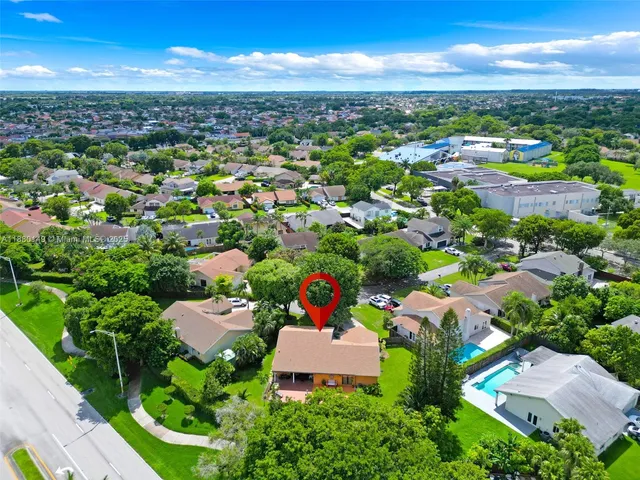 an aerial view of residential houses with outdoor space
