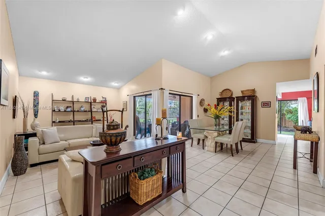 a living room with furniture a rug and white walls
