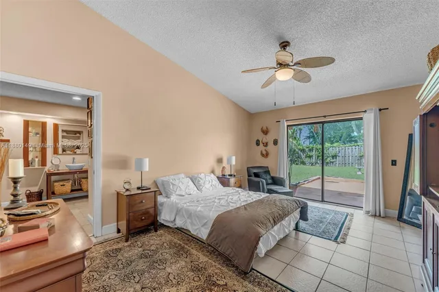 a bedroom with a bed and glass door