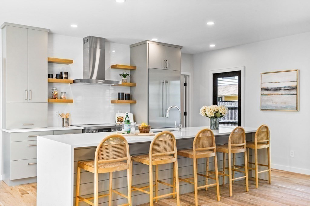 16 Eldridge Court Hingham, MA 02043 - Photo 13 of 41 a kitchen with granite countertop cabinets and chairs