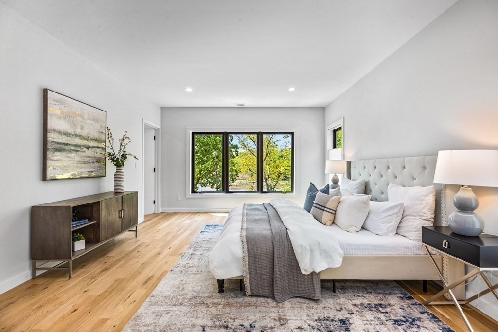16 Eldridge Court Hingham, MA 02043 - Photo 27 of 41 a spacious bedroom with a bed a couch and large window