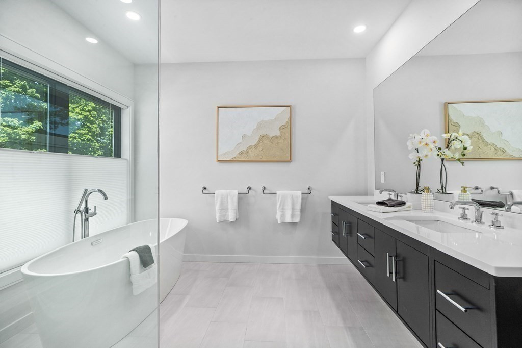 16 Eldridge Court Hingham, MA 02043 - Photo 30 of 41 a spacious bathroom with a double vanity sink a mirror and a bathtub