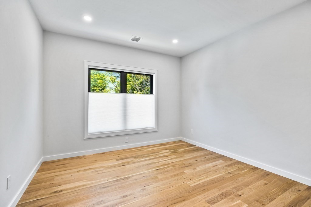 16 Eldridge Court Hingham, MA 02043 - Photo 35 of 41 an empty room with wooden floor and windows