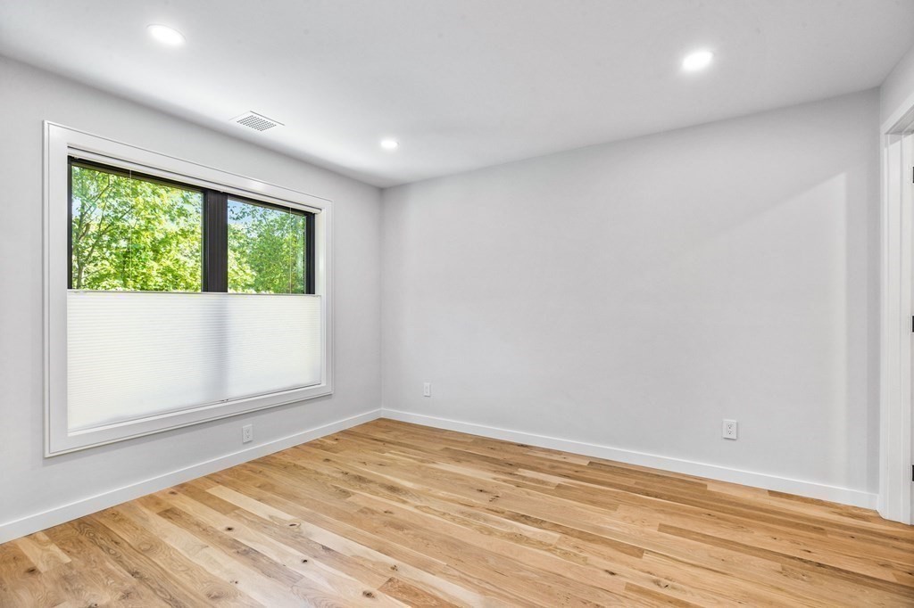 16 Eldridge Court Hingham, MA 02043 - Photo 36 of 41 an empty room with wooden floor and windows