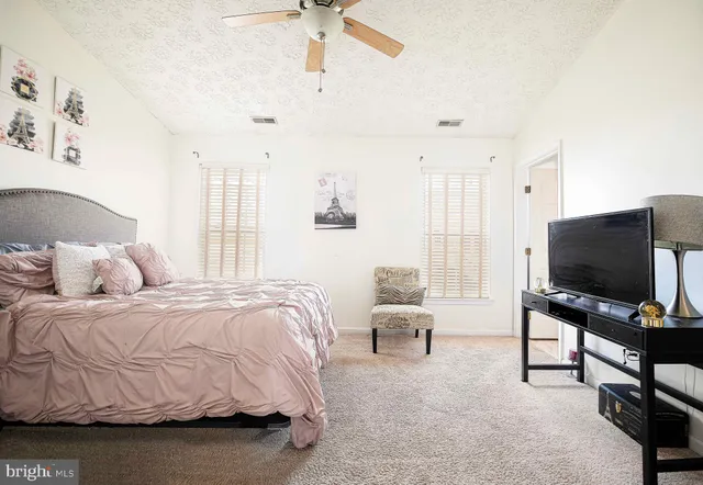 a bedroom with furniture and a flat screen tv