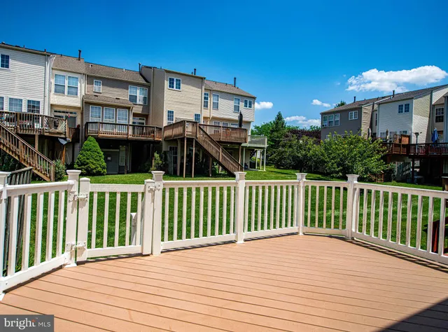 a view of a house with wooden deck