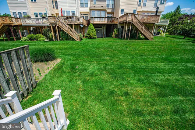a view of a house with a yard and sitting area
