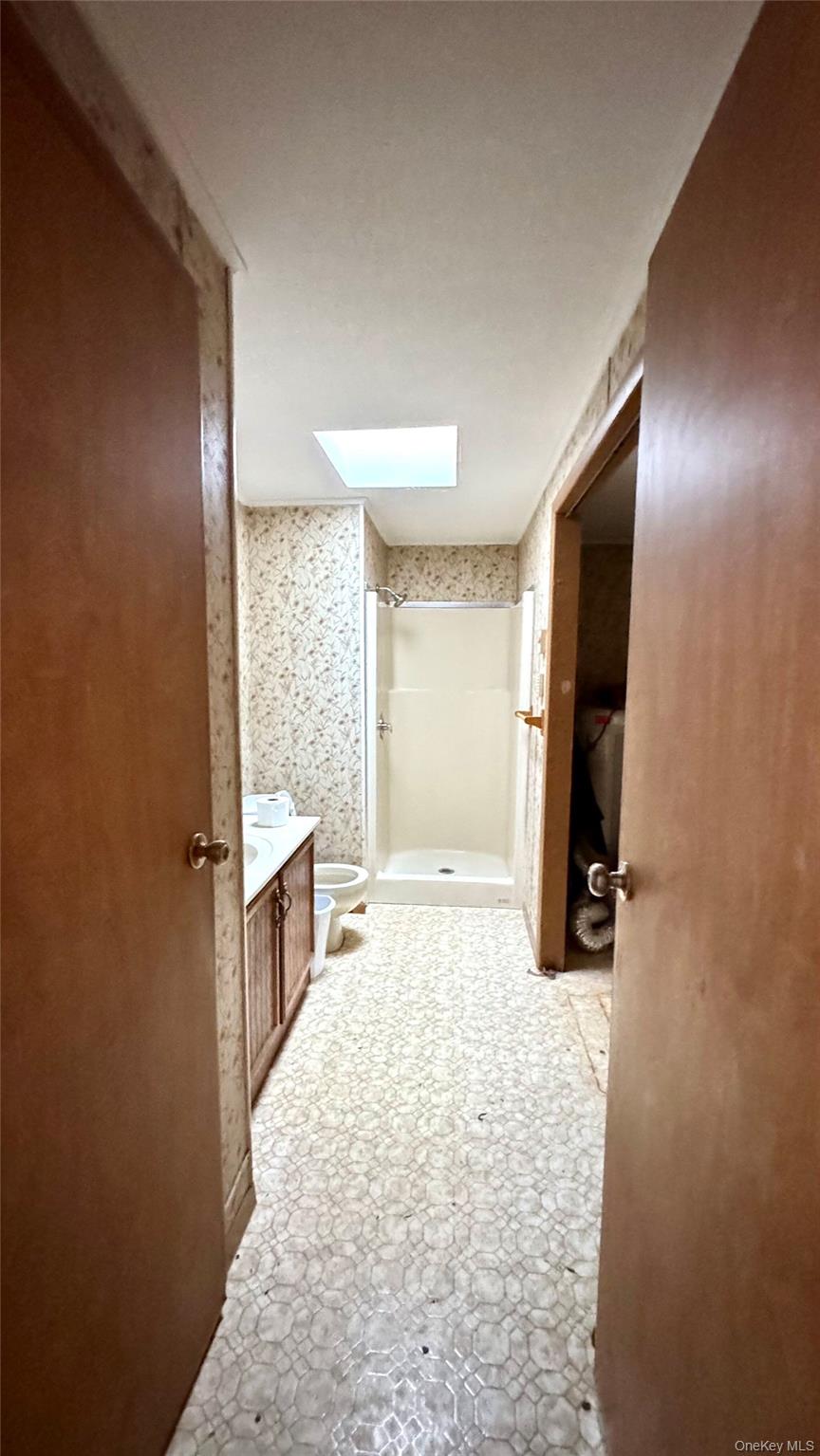 61 Gould Road Centereach, NY 11720 - Photo 12 of 22 a spacious bathroom with a granite countertop sink and a mirror