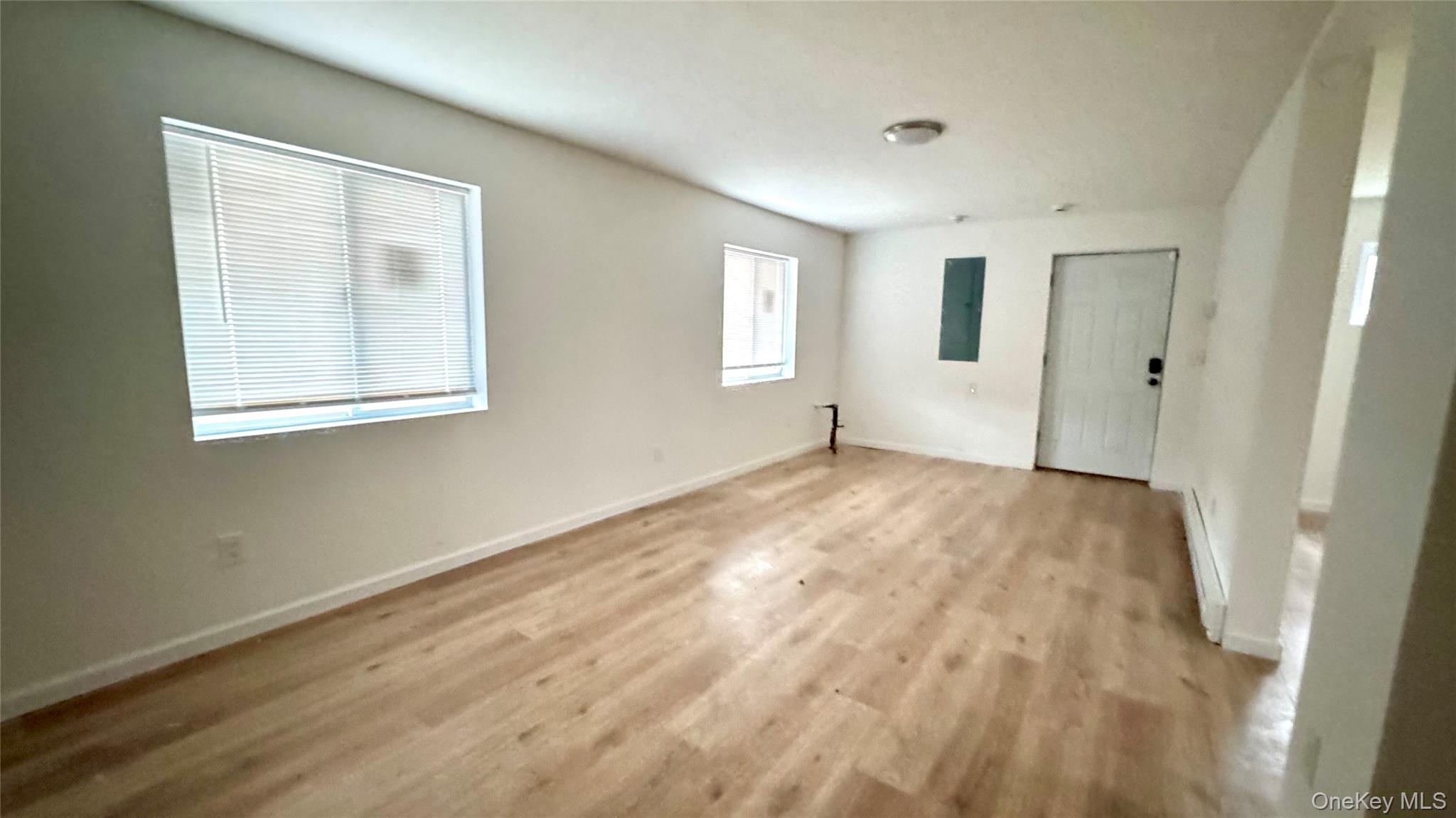 61 Gould Road Centereach, NY 11720 - Photo 17 of 22 a view of an empty room with wooden floor and a window